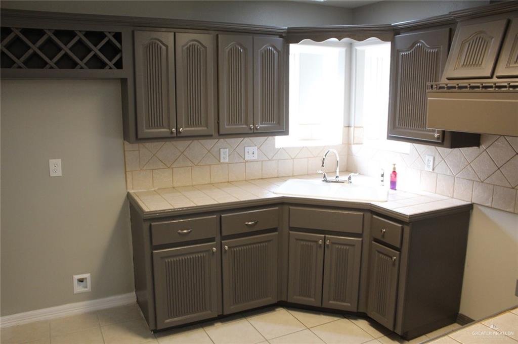 3824 Umar Avenue McAllen, TX 78504 - Photo 10 of 15 a sink with wooden cabinets