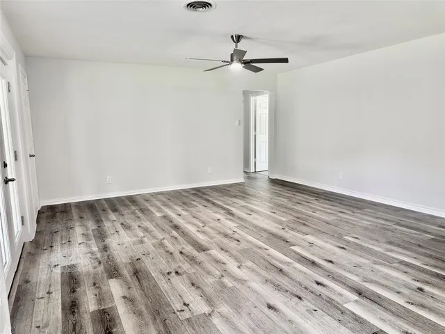 a view of a room with wooden floor