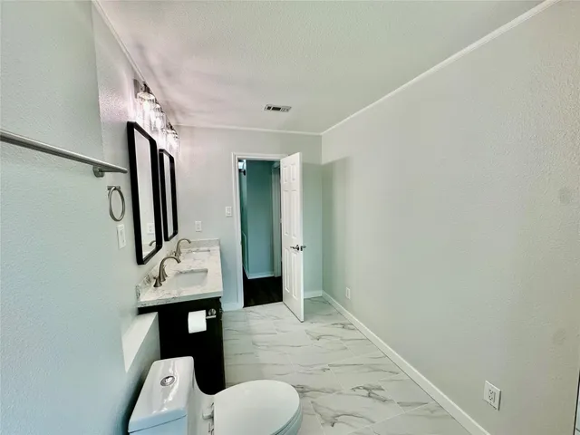 a bathroom with a sink toilet and mirror
