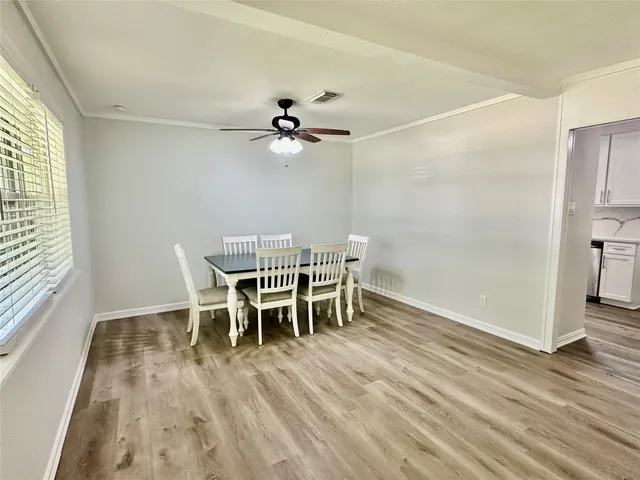 a view of a dining room with furniture and wooden floor