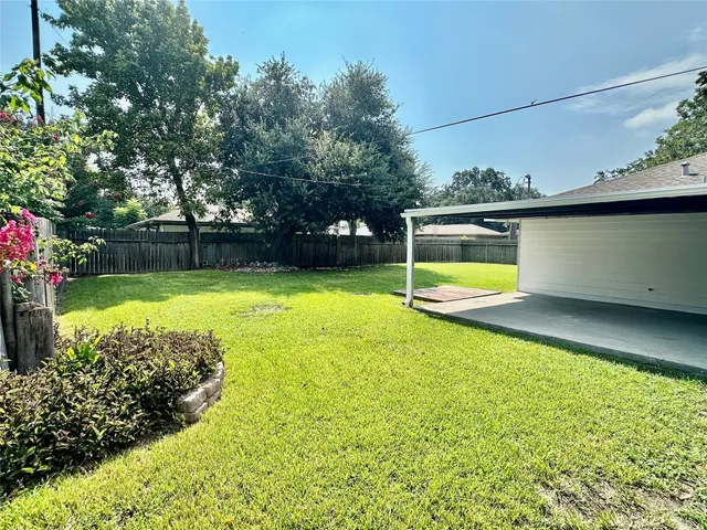 a view of a swimming pool with an outdoor seating and a yard