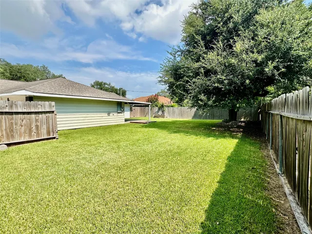 a view of an house with backyard space and balcony