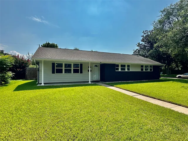 a front view of a house with a yard table and chairs