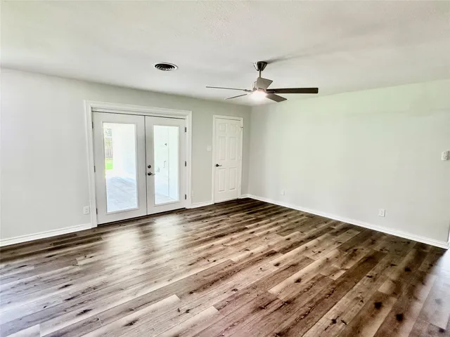 a view of empty room with wooden floor