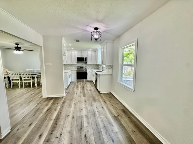 a view of a kitchen with a sink and a window