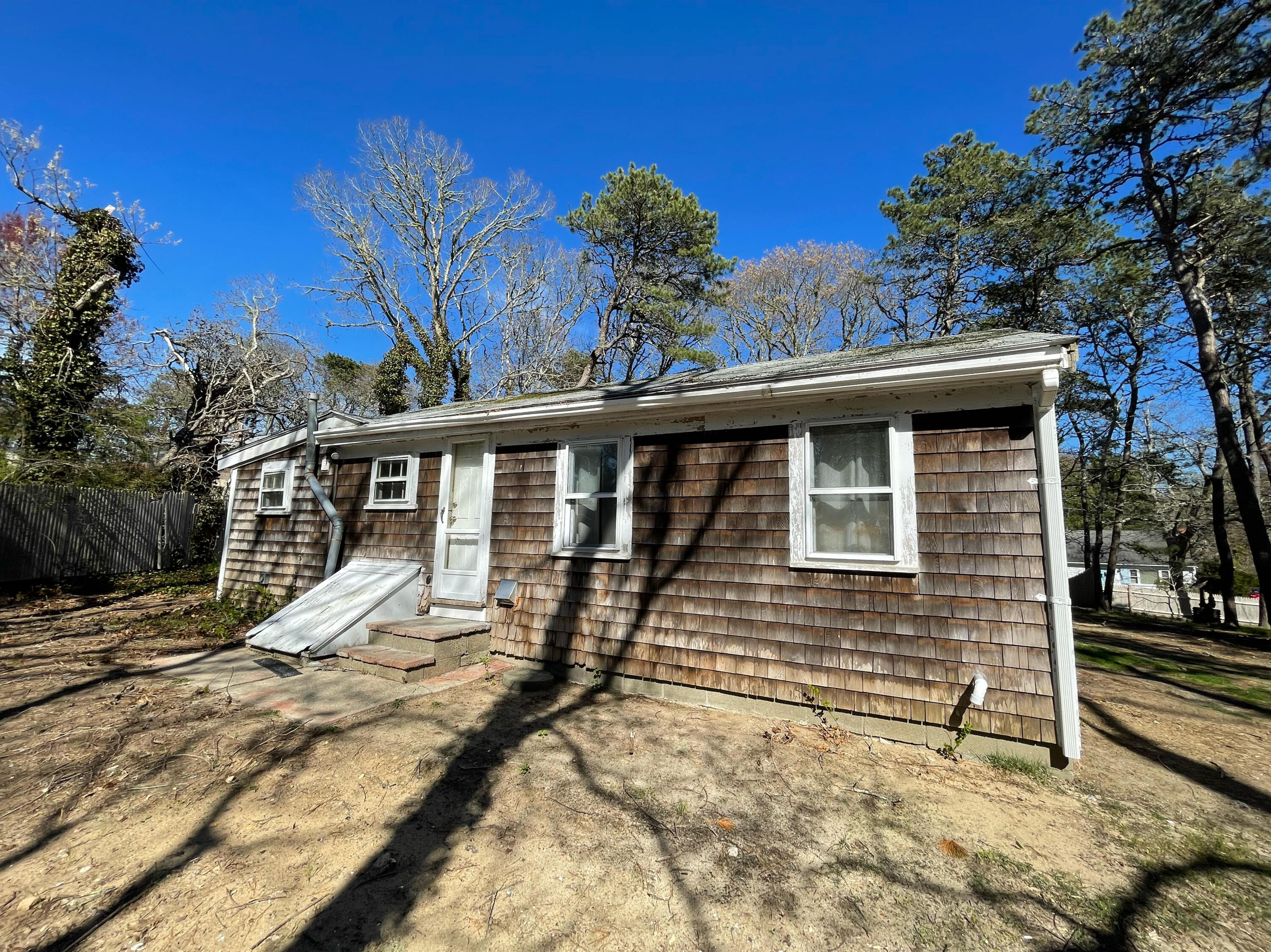 175 Telegraph Road Dennis Port, MA 02639 - Photo 4 of 12 a view of a house with a small yard