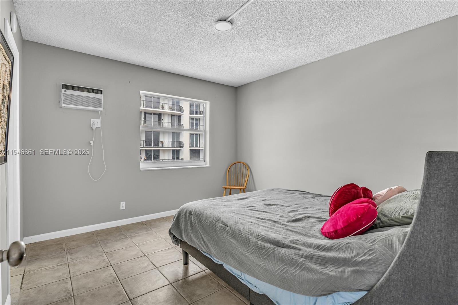 200 South Birch Road, Unit 1015 Fort Lauderdale, FL 33316 - Photo 17 of 36 a bedroom with a bed and a window