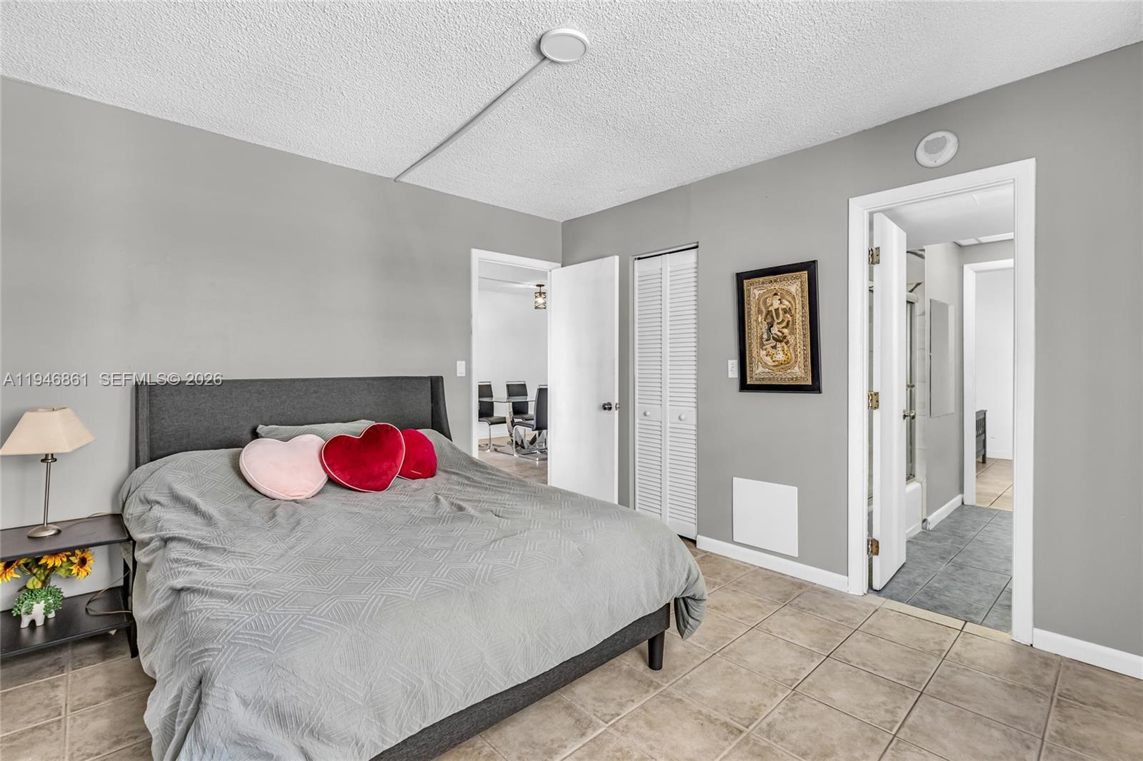 200 South Birch Road, Unit 1015 Fort Lauderdale, FL 33316 - Photo 18 of 36 a bedroom with a bed and a chandelier