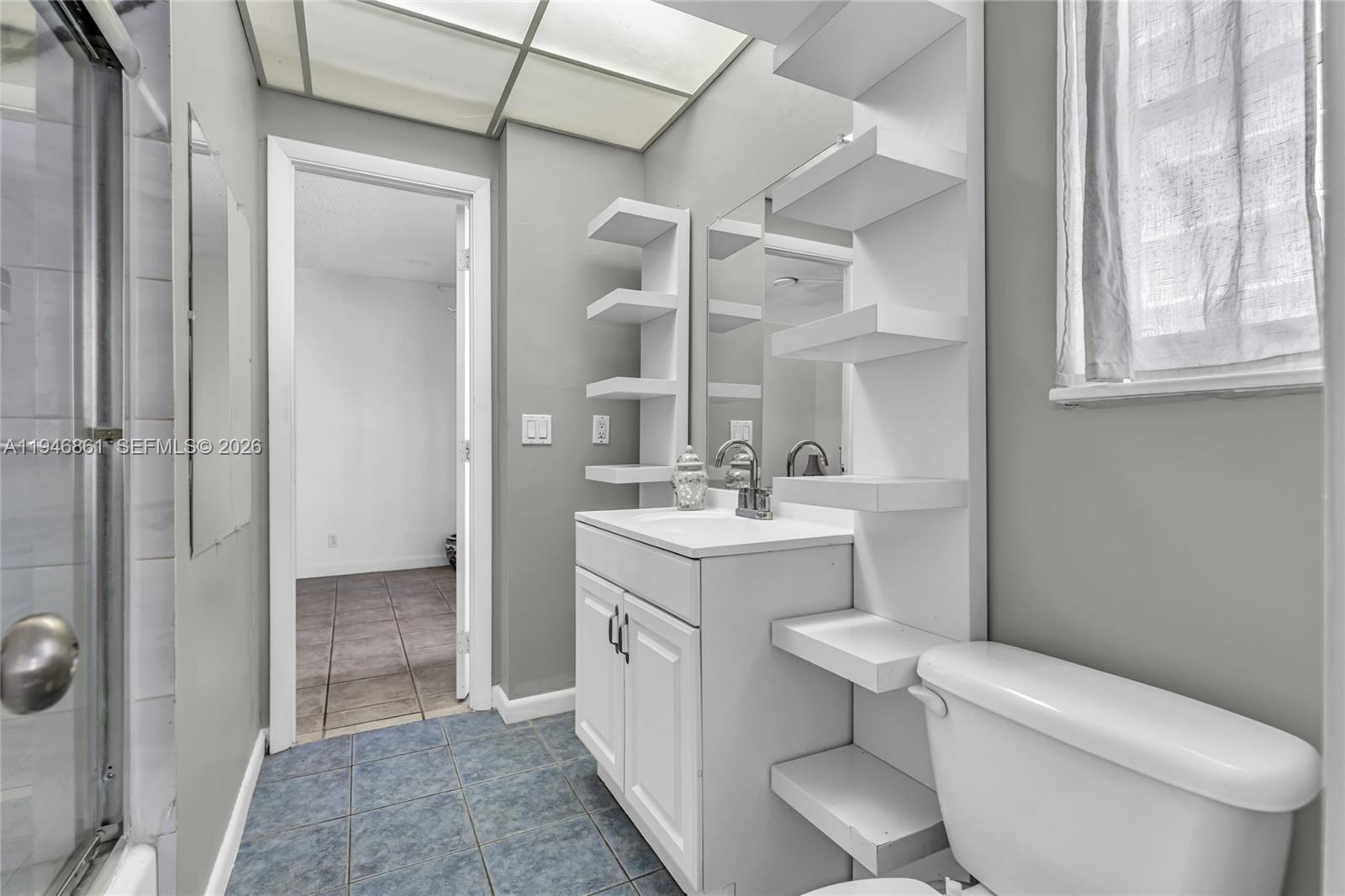 200 South Birch Road, Unit 1015 Fort Lauderdale, FL 33316 - Photo 19 of 36 a bathroom with a toilet sink vanity and mirror