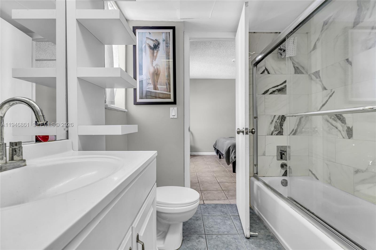 200 South Birch Road, Unit 1015 Fort Lauderdale, FL 33316 - Photo 20 of 36 a bathroom with a bathtub shower sink mirror and toilet