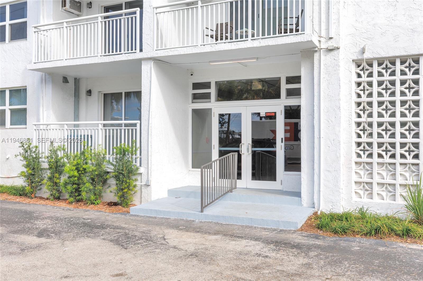 200 South Birch Road, Unit 1015 Fort Lauderdale, FL 33316 - Photo 30 of 36 a front view of a house with a yard and garage