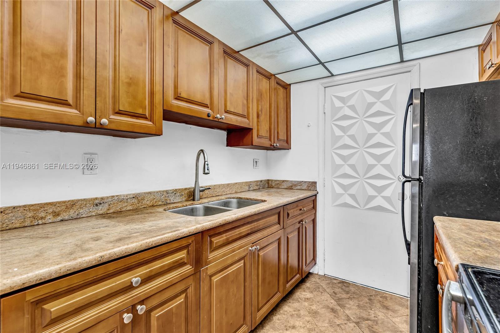 200 South Birch Road, Unit 1015 Fort Lauderdale, FL 33316 - Photo 8 of 36 a kitchen with stainless steel appliances granite countertop a sink a refrigerator and cabinets