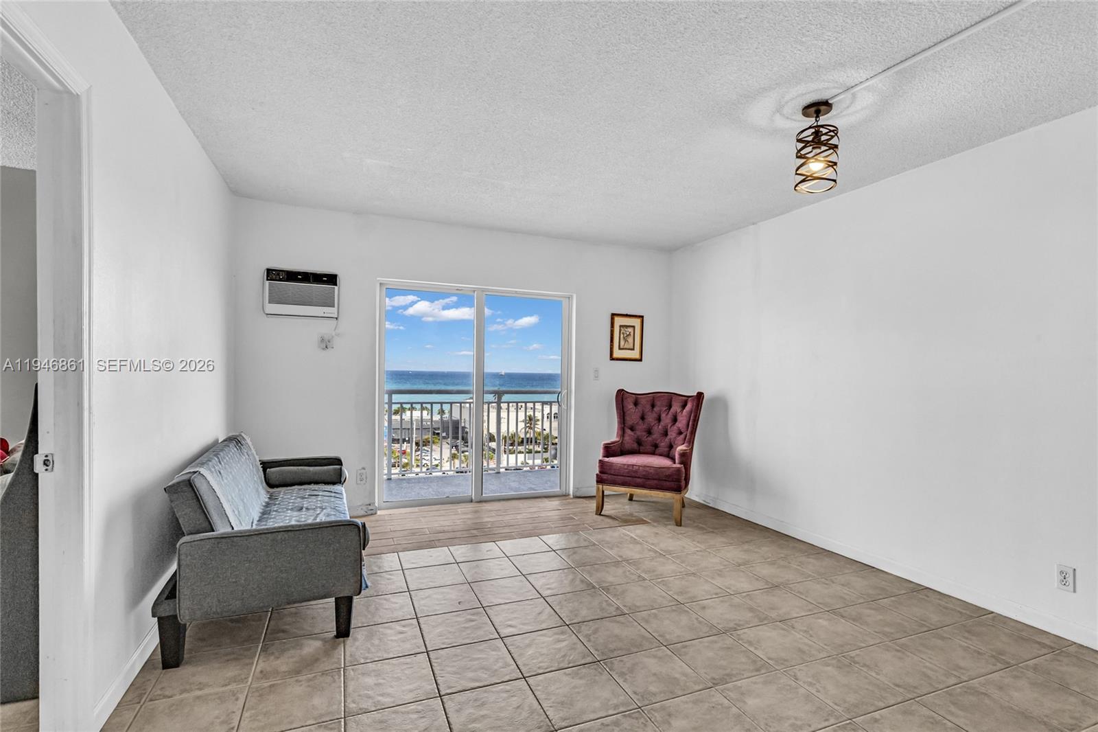 200 South Birch Road, Unit 1015 Fort Lauderdale, FL 33316 - Photo 10 of 36 a living room with furniture and a window