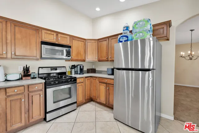 a kitchen with refrigerator and cabinets