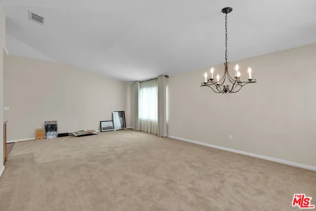 a view of a kitchen with a sink and chandelier