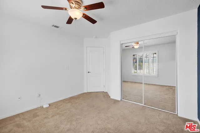 a bed room with a bed and a chair