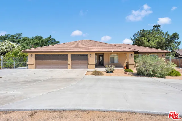 a front view of a house with yard and porch