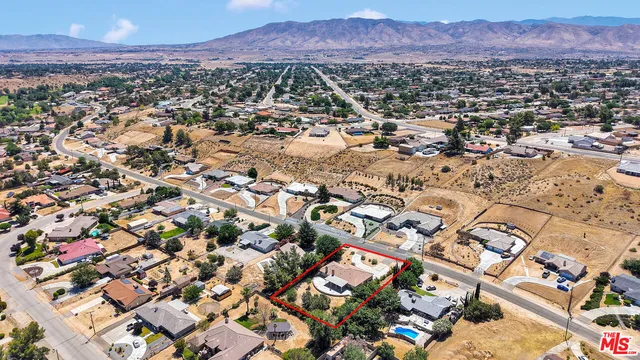 an aerial view of residential house and outdoor space