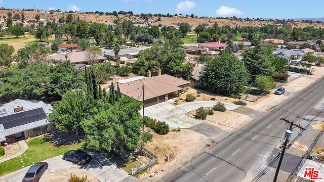 an aerial view of multiple houses with yard