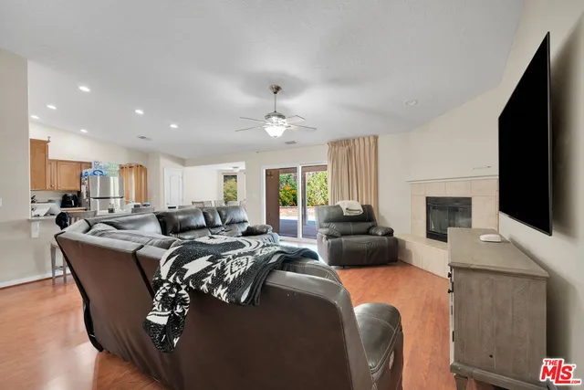 a living room with furniture and a dining table with kitchen view