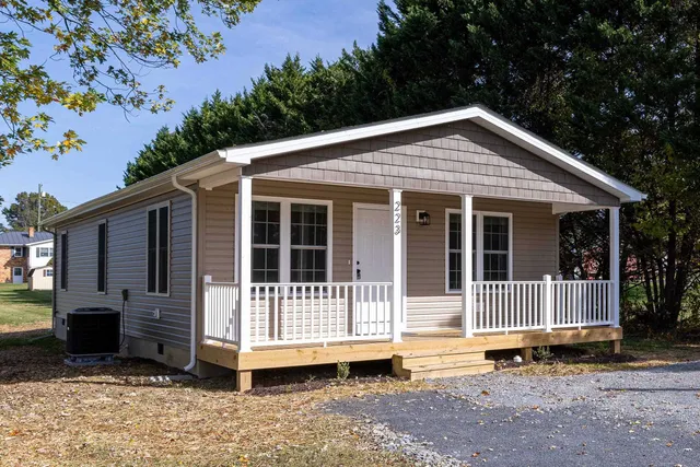 a kitchen with granite countertop white cabinets and stainless steel appliances