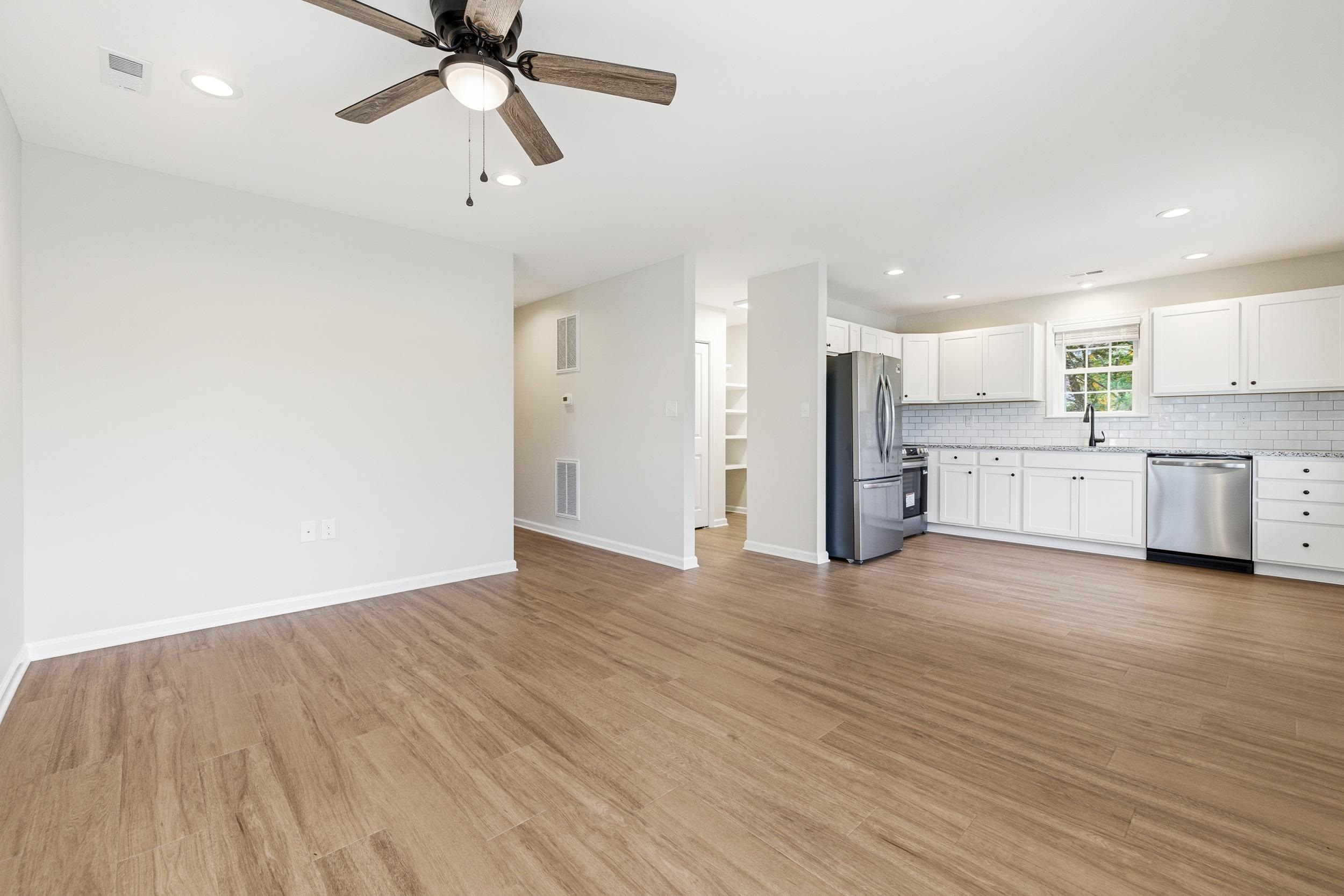 223 Fairview Road Luray, VA 22835 - Photo 12 of 63 a view of a kitchen with a sink and dishwasher a refrigerator with wooden floor