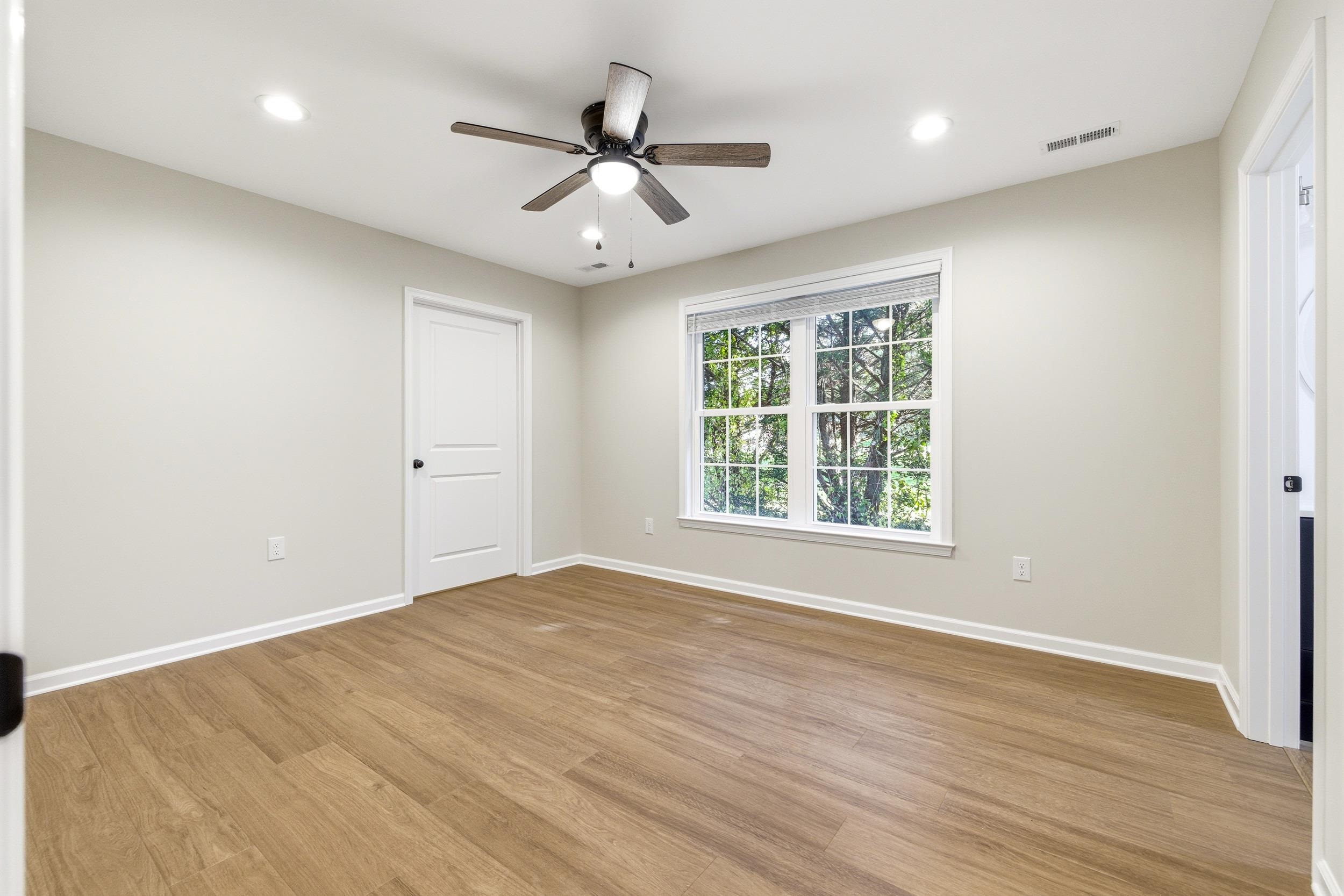 223 Fairview Road Luray, VA 22835 - Photo 16 of 63 a view of an empty room with wooden floor and a window