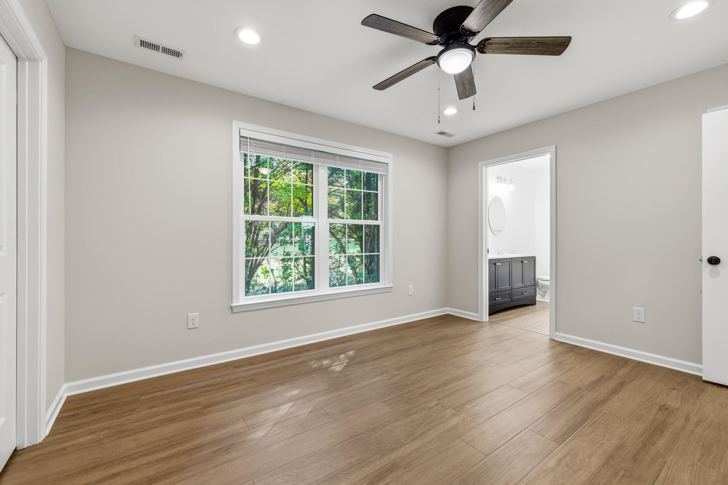 223 Fairview Road Luray, VA 22835 - Photo 19 of 63 an empty room with wooden floor chandelier ceiling fan and windows