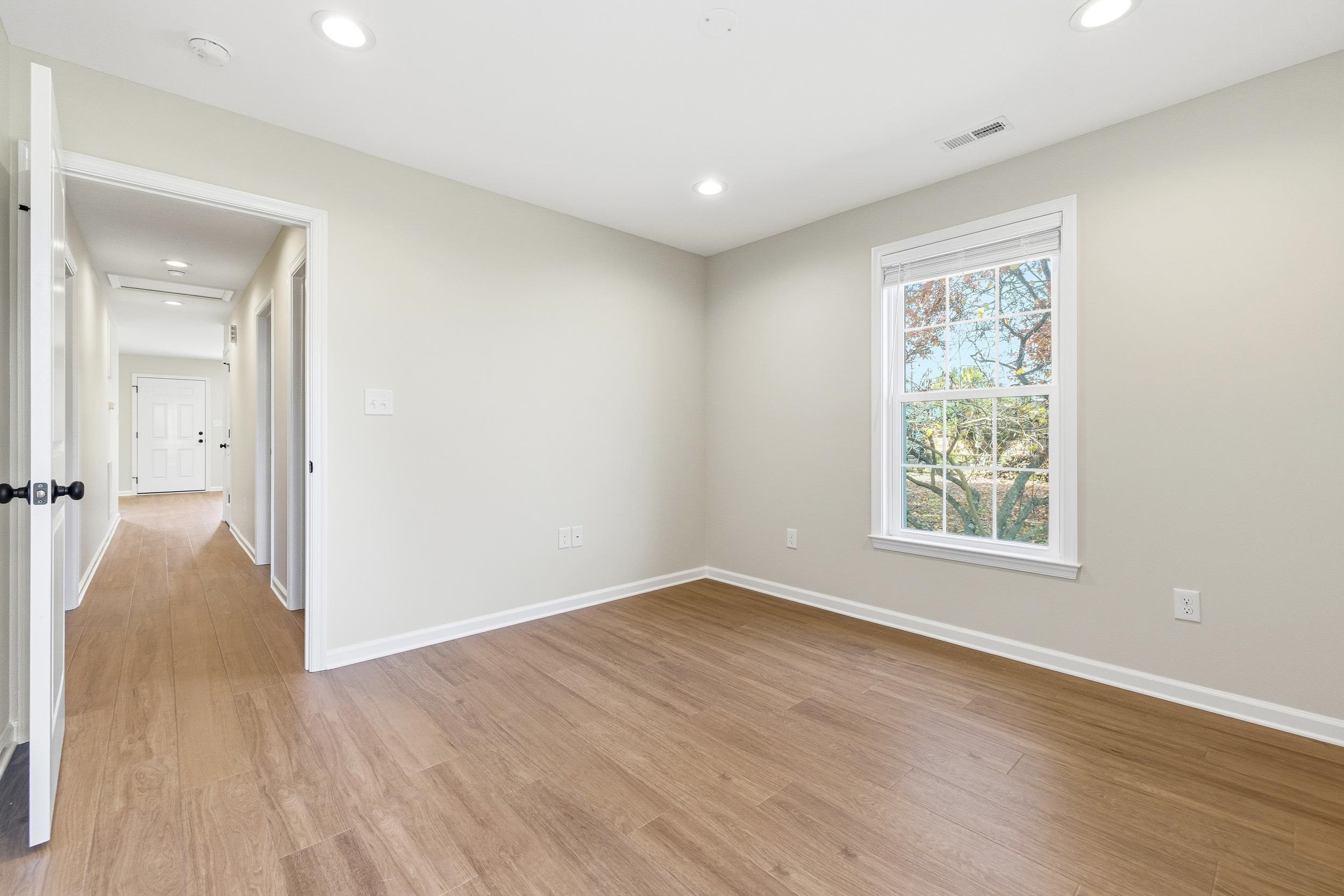 223 Fairview Road Luray, VA 22835 - Photo 29 of 63 a view of an empty room with wooden floor and a window