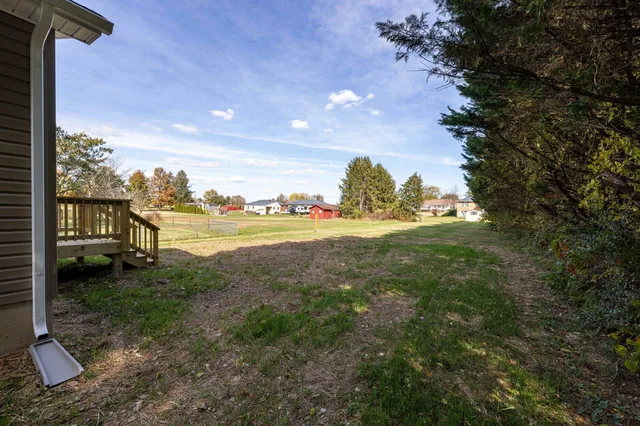 a view of a yard with wooden fence