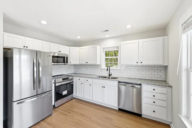 a stove top oven sitting inside of a kitchen