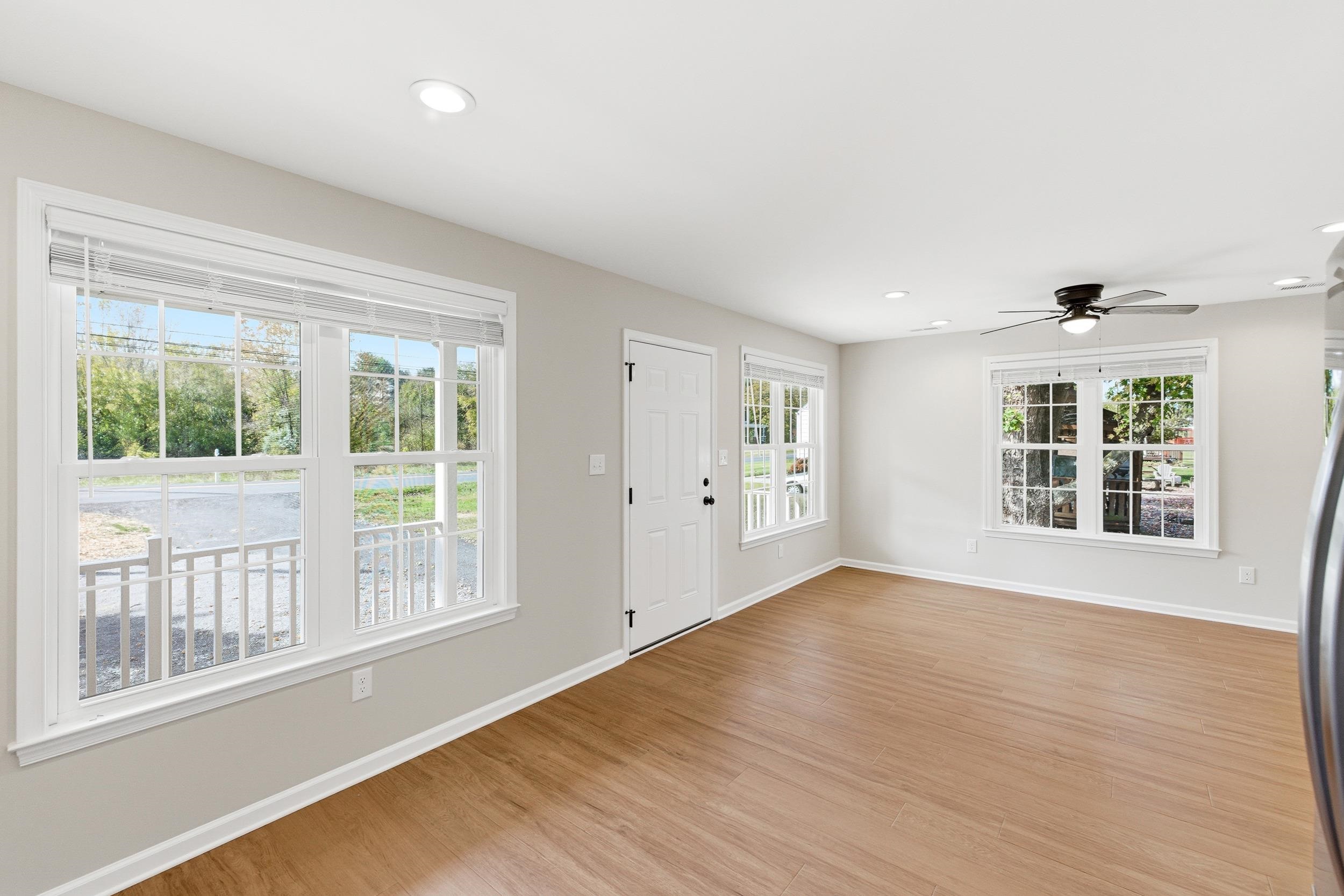 223 Fairview Road Luray, VA 22835 - Photo 10 of 63 a view of an empty room with wooden floor and a window