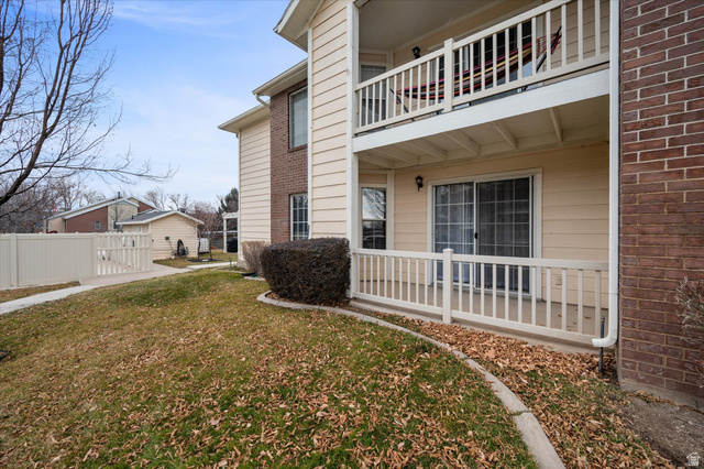 2095 South Main Street, Unit 13 Bountiful, UT 84010 - Photo 25 of 45 View of property exterior featuring a balcony, brick siding, and a gate