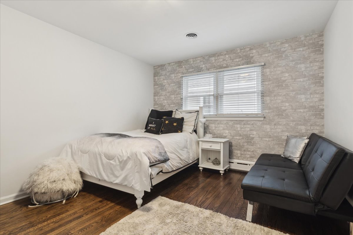 918 Oxford Road Deerfield, IL 60015 - Photo 16 of 26 a bedroom with a bed and wooden floor