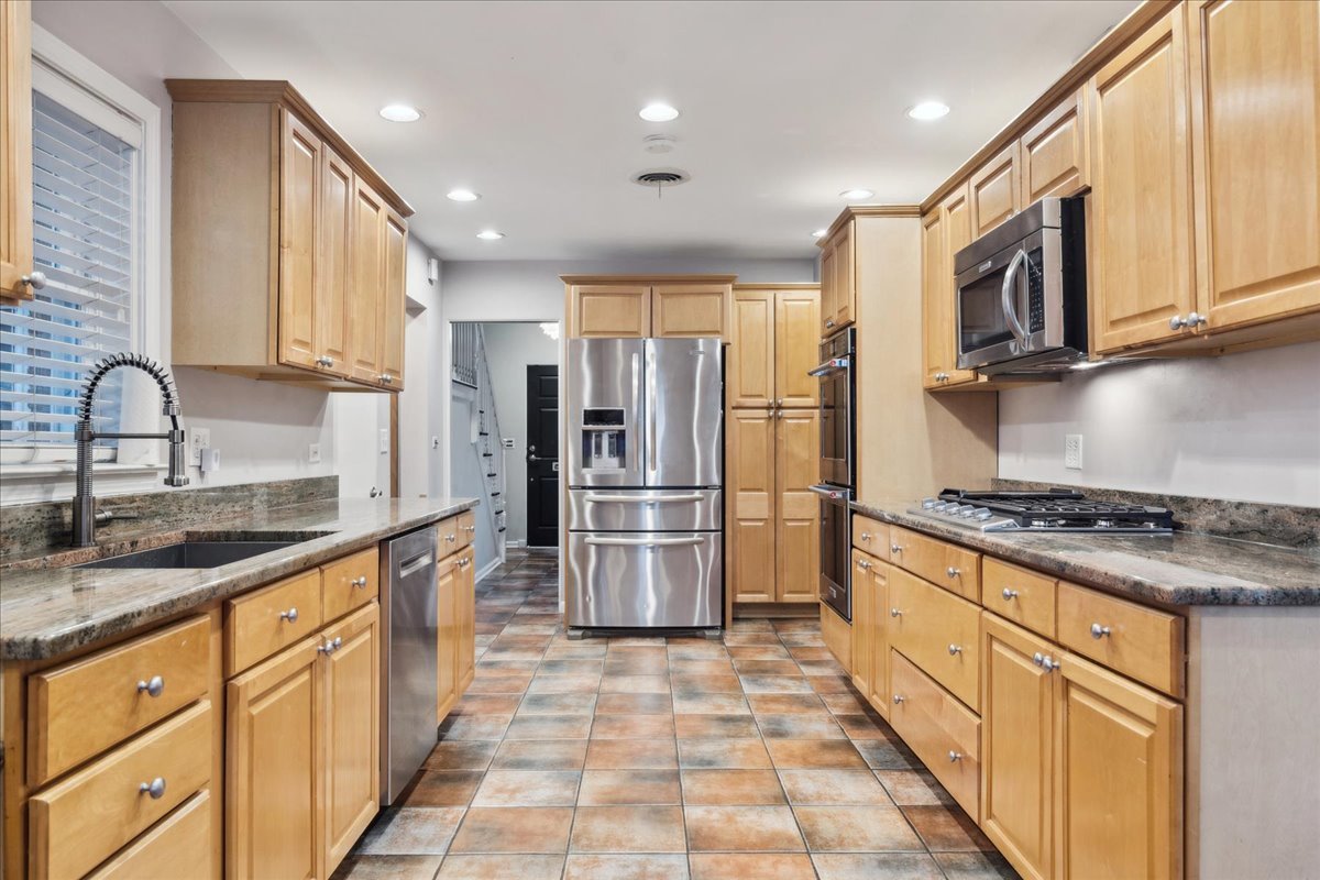 918 Oxford Road Deerfield, IL 60015 - Photo 8 of 26 a kitchen with stainless steel appliances granite countertop a stove a sink and a refrigerator