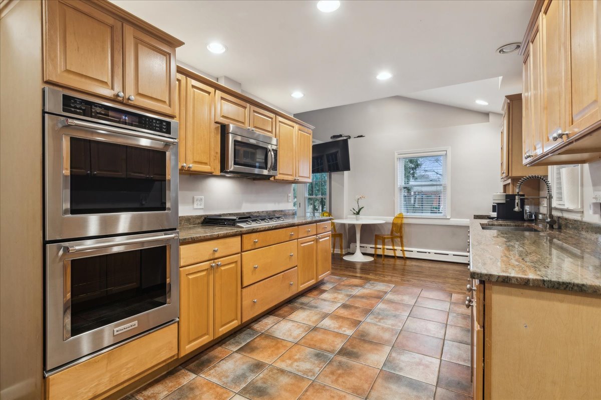 918 Oxford Road Deerfield, IL 60015 - Photo 9 of 26 a kitchen with stainless steel appliances granite countertop a stove microwave and sink