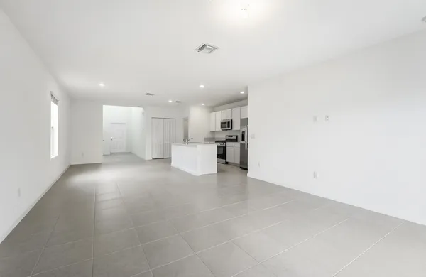 a view of a kitchen with a sink and a refrigerator