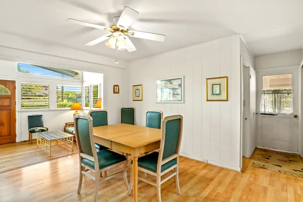 a view of a dining room with furniture and wooden floor