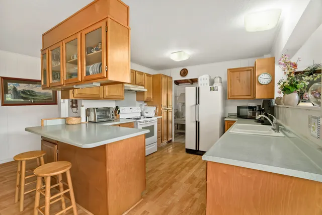 a kitchen with stainless steel appliances granite countertop a sink and cabinets