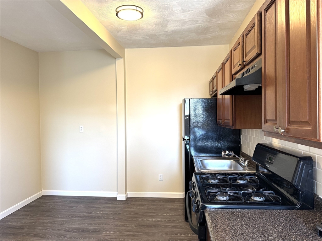 838 Western Avenue, Unit 2R Lynn, MA 01905 - Photo 2 of 9 a kitchen with a stove and a cabinet