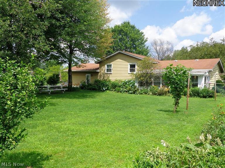 3540 Susan Road Ravenna, OH 44266 - Photo 2 of 11 The relatively level fenced backyard is park-like with lovely perennial gardens and a shed.