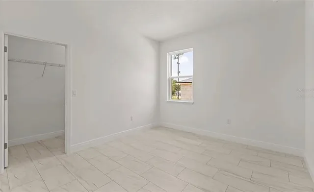 a bathroom with a granite countertop shower and a toilet