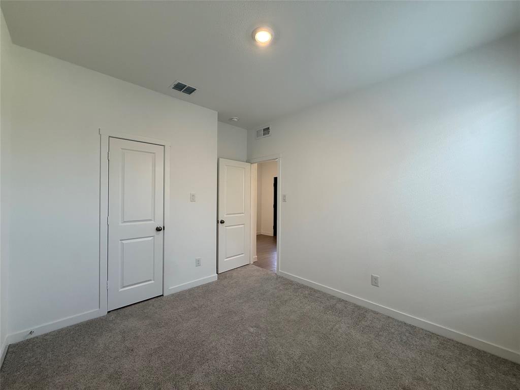 3025 Timber Rdg Drive Anna, TX 75409 - Photo 13 of 23 Plush grey carpeting, white interior doors, and a recessed ceiling light