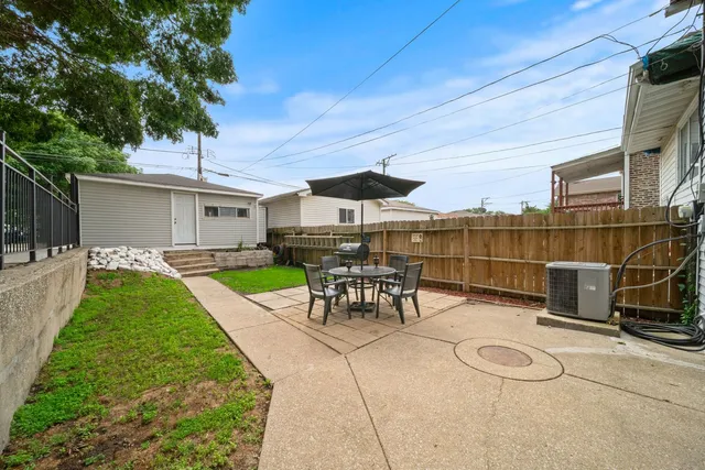 a view of a house with a yard and sitting area