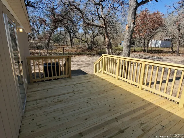 a view of a house with wooden deck