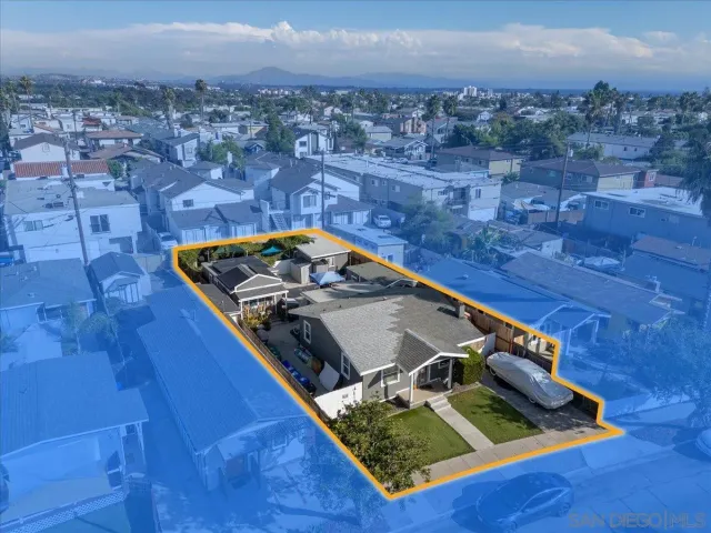 an aerial view of a house with a backyard