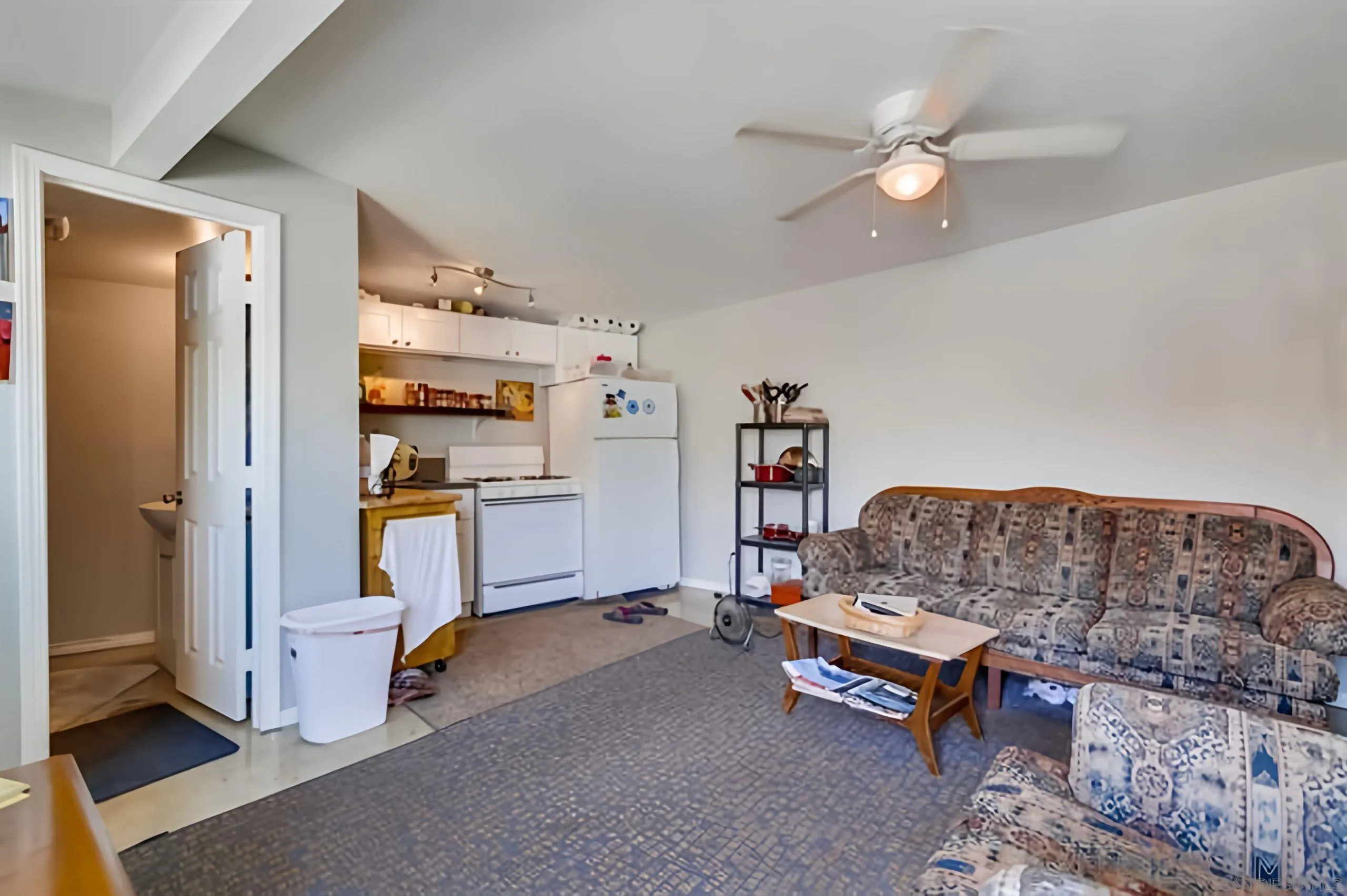 4667-69 35th Street San Diego, CA 92116 - Photo 12 of 29 a living room with furniture and a chandelier