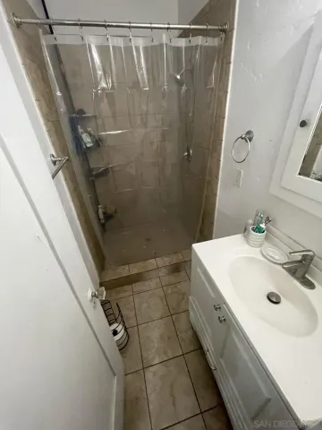 a bathroom with a sink a mirror and shower