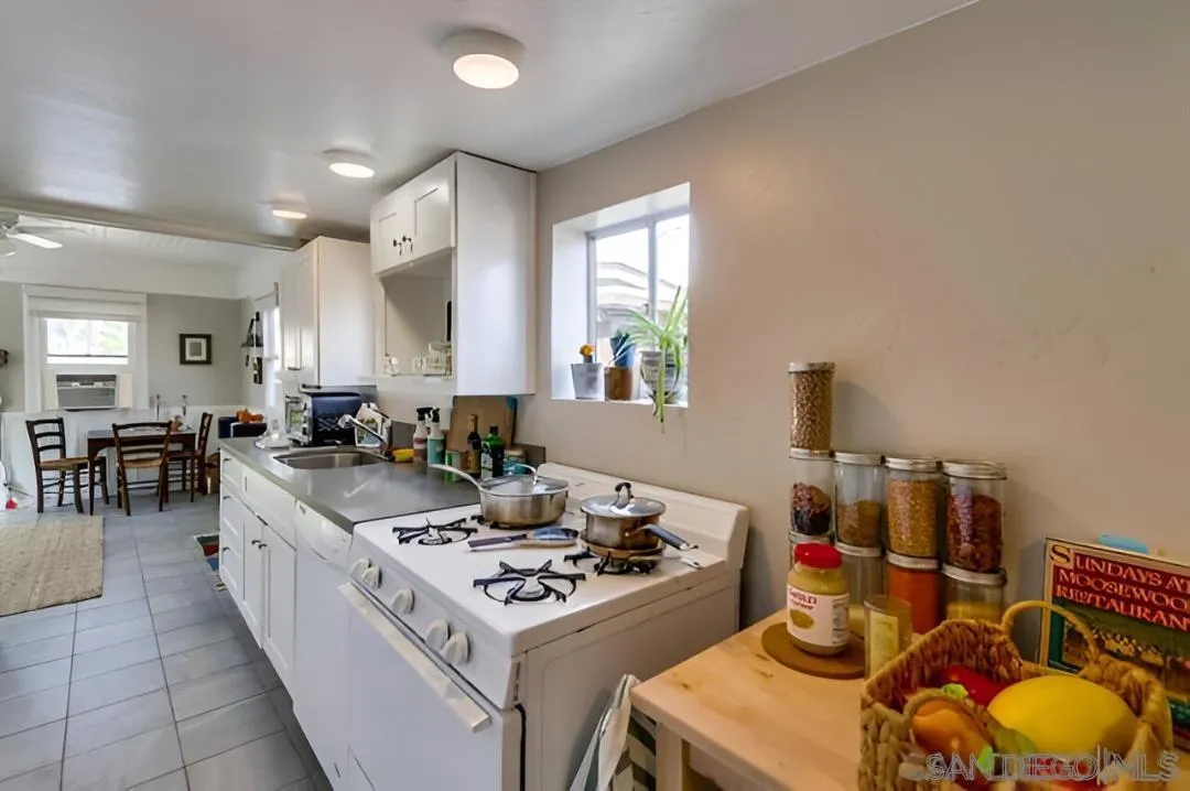 4667-69 35th Street San Diego, CA 92116 - Photo 24 of 29 a kitchen with a sink stove and cabinets