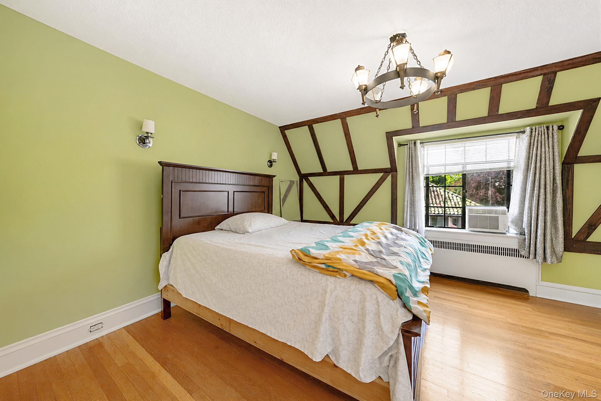18240 Avon Road Queens, NY 11432 - Photo 18 of 30 Bedroom featuring exposed timber framing and light wood-finish flooring